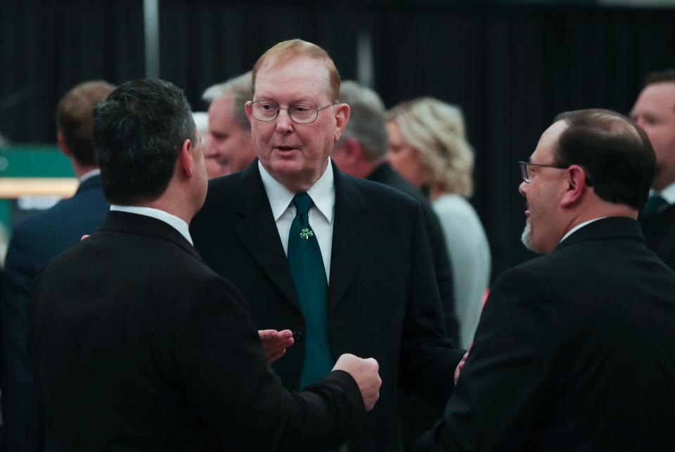 Former Flaget High School and U of L QB Oscar Brohm, center, chatted with guests before the Trinity High School Hall of Fame Dinner, where Oscar and his son, Brian, were inducted Thursday night. Oscar has been the quarterbacks coach at Trinity for decades.