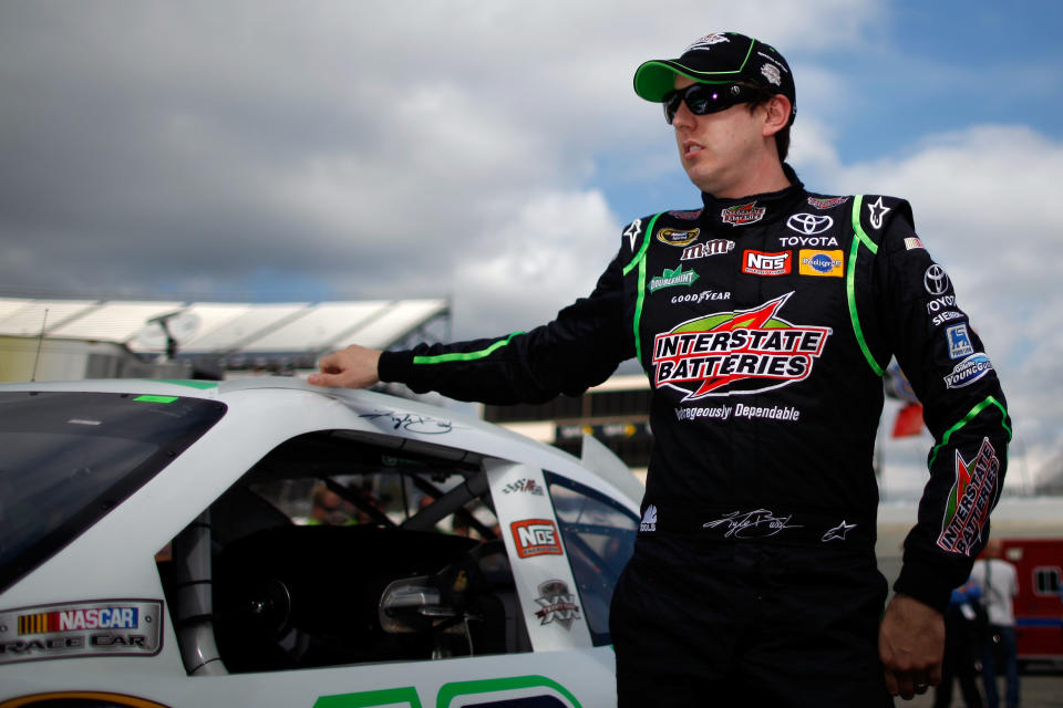 DOVER, DE - OCTOBER 01: Kyle Busch, driver of the #18 Interstate Batteries Toyota, looks on during qualifying for the NASCAR Sprint Cup Series AAA 400 at Dover International Speedway on October 1, 2011 in Dover, Delaware. (Photo by Chris Gaythen/Getty Images)