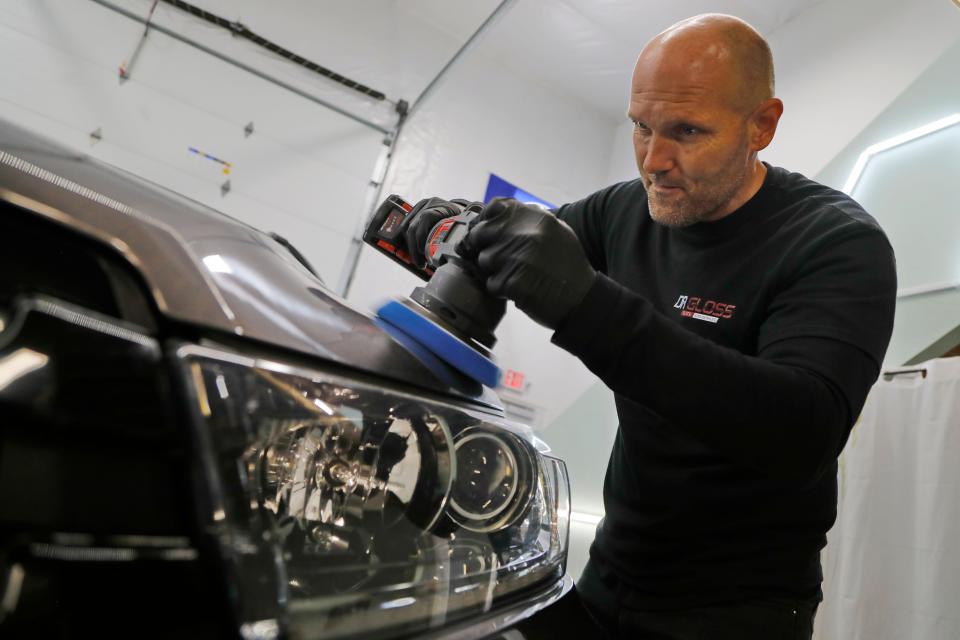 Arnold Chapman works on detailing an SUV at his Elite Detailing shop on Reed Road in Dartmouth. Mr. Chapman will be holding his Second Annual Heroes Thanksgiving Dinner in this shop.