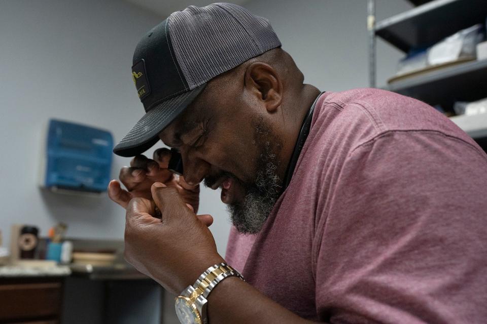 Howard Clark, descendant of Tom Cook, looks at an artifact found from Cook's blacksmith shop. When TxDOT wanted to widen a road in Denton County, they encountered the remains of an old hotel and a Black-owned blacksmith shop from the late 1800s.