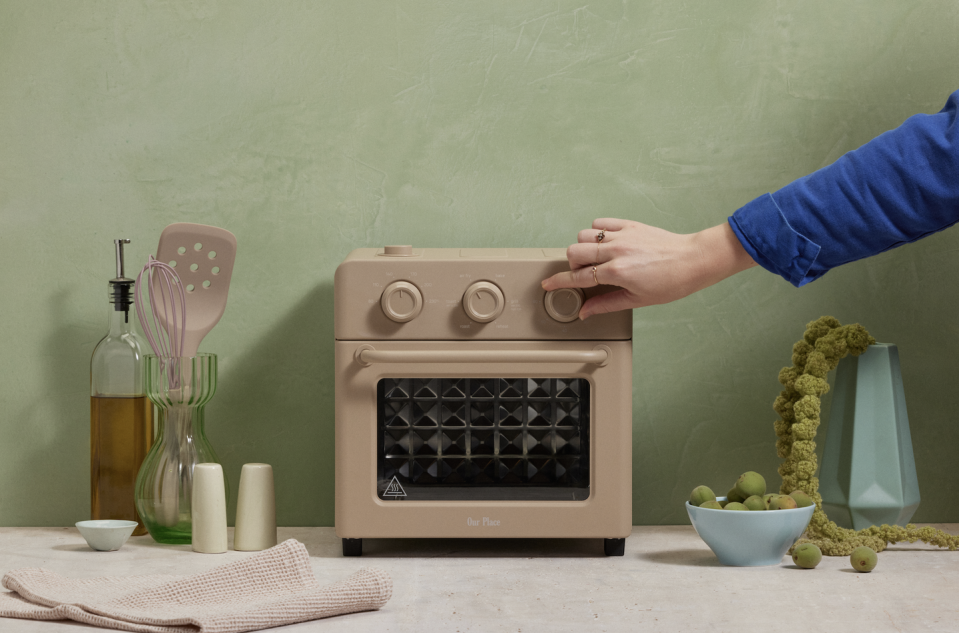 Kitchen counter with kitchen utensils and compact oven