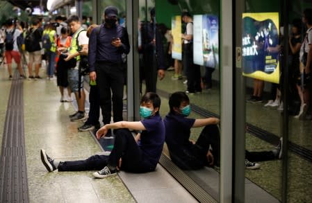 People are seen on a platform at Fortress Hill station during a disruption of Mass Transit Railway (MTR) services by protesters in Hong Kong