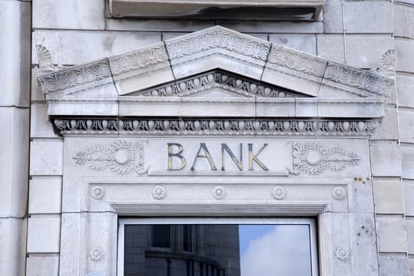 Entrance to a building, with "BANK" etched on top of the doorway.