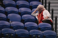 A spectator watches the second round match between Emil Ruusuvuori of Finland and Daniil Medvedev of Russia at the Australian Open tennis championships at Melbourne Park, Melbourne, Australia, Friday, Jan. 19, 2024. (AP Photo/Andy Wong)