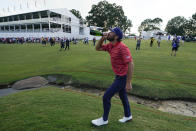 Max Homa drinks champagne after the USA team defeated the International team in match play at the Presidents Cup golf tournament at the Quail Hollow Club, Sunday, Sept. 25, 2022, in Charlotte, N.C. (AP Photo/Julio Cortez)