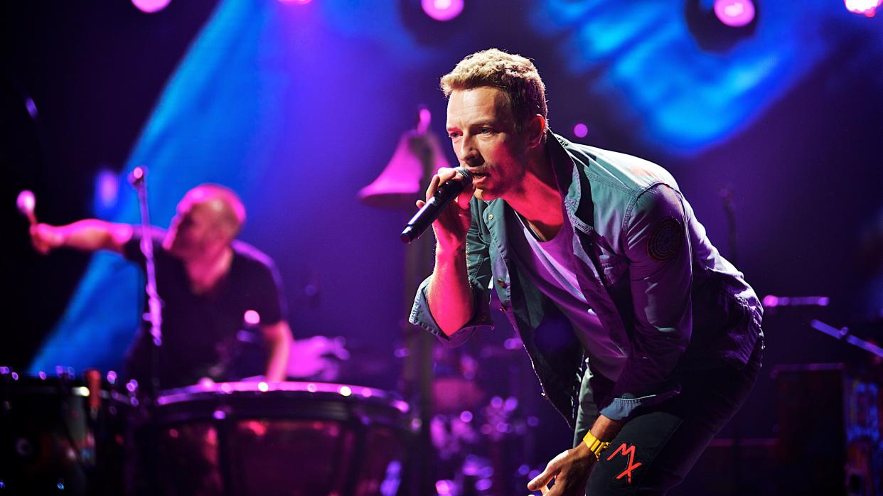 Chris Martin on stage with Coldplay