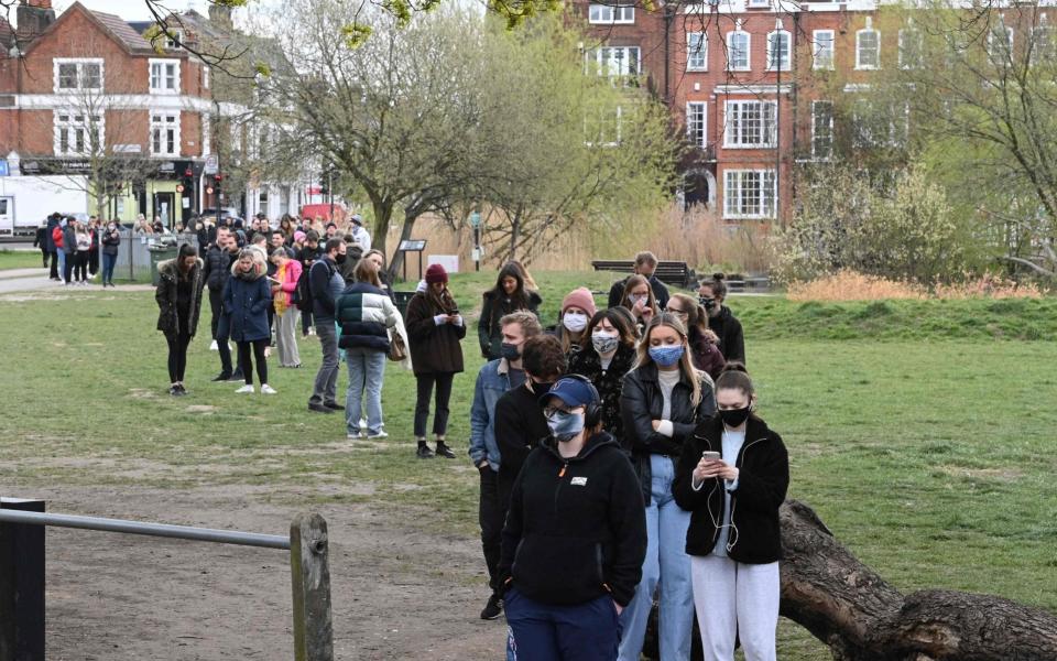 People queue to take a Covid-19 test at a mobile novel coronavirus testing centre on Clapham Common in south London -  DANIEL LEAL-OLIVAS  / AFP