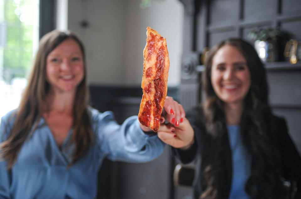 Higher Steaks head of R&D Ruth Faram (l) and CEO Benjamina Bollag (r) with their lab-grown bacon prototype