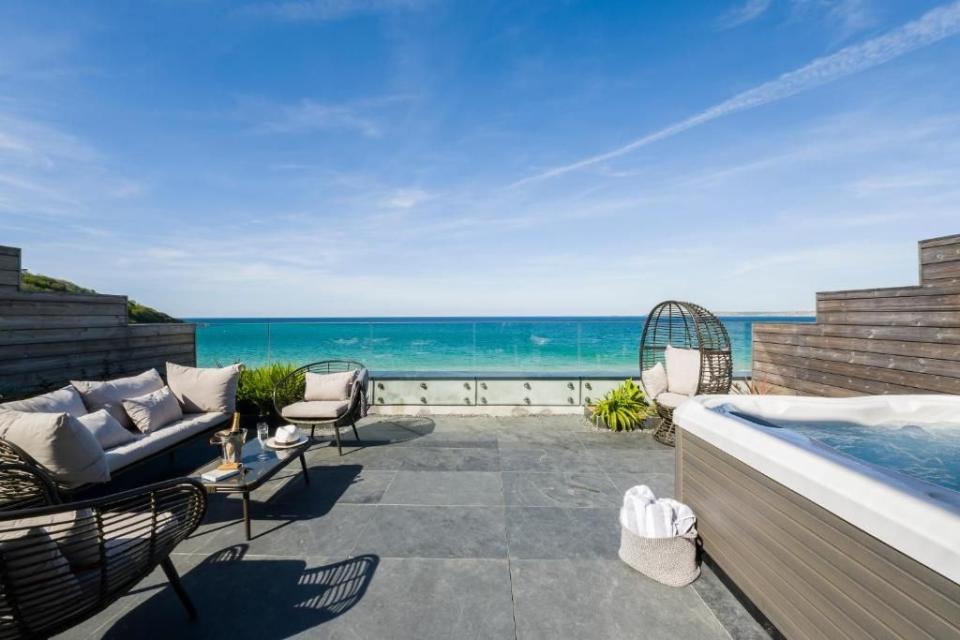 <p>At this glorious beach hotel near St Ives, there's a collection of villas to book for a luxurious seaside staycation. Expect terrific views of the golden sands or garden, hot tubs, private sun decks and floor-to-ceiling windows.</p><p>The <a href="https://www.booking.com/hotel/gb/carbis-bay-hotel.en-gb.html?aid=2070929&label=hotels-with-cottages#room_22583113" rel="nofollow noopener" target="_blank" data-ylk="slk:Villa with Sea View;elm:context_link;itc:0;sec:content-canvas" class="link ">Villa with Sea View</a> comes with two large bedrooms and two bathrooms, as well as plenty of space to dine and lounge. When it comes to eating, meals can be delivered to your villa, so you can experience the hotel services in your own private space. </p><p>And there's more: cottages, apartments and lodges make up the self-catering offering at Carbis Bay Hotel.</p><p><a class="link " href="https://www.booking.com/hotel/gb/carbis-bay-hotel.en-gb.html?aid=2070929&label=hotels-with-cottages" rel="nofollow noopener" target="_blank" data-ylk="slk:CHECK AVAILABILITY;elm:context_link;itc:0;sec:content-canvas">CHECK AVAILABILITY </a></p>