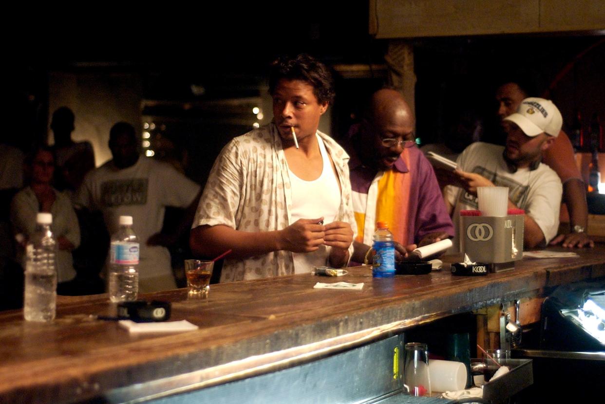 Terrence Howard, from left, Isaac Hayes and Craig Brewer are at the Poplar Lounge for a scene in Brewer's movie "Hustle & Flow." Brewer looks at the setup for a shot through a mobile monitor while Howard and Hayes take a break.