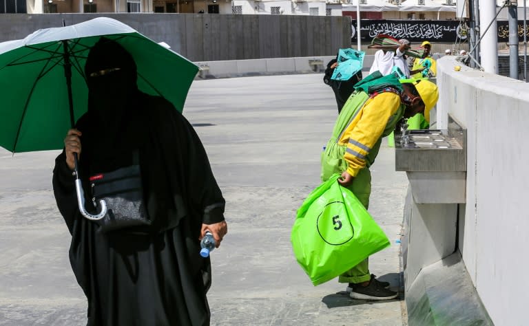 A sanitation worker drinks from a fountain during the annual hajj pilgrimage in Mecca on August 22, 2018