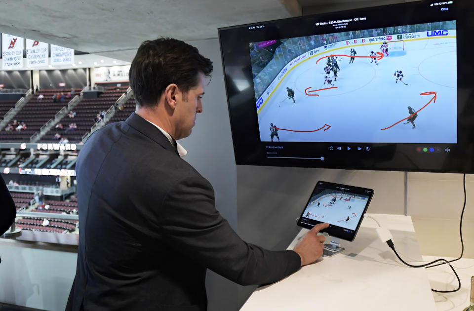 NHL senior director of coaching and general manager of technology Brant Berglund demonstrates the latest advances in puck and player tracking at a tech showcase before an NHL hockey game between the Buffalo Sabres and New Jersey Devils,Thursday, April 21, 2022, in Newark, N.J. Some data from the NHL’s puck and player tracking system is expected to be publicly available during the upcoming playoffs, and that’s just the start of some of the technological twists that are coming to hockey arenas and broadcasts sooner than later. Custom camera angles and replays for fans at their seats and virtual and augmented reality are among the advancements the league is working on. (AP Photo/Bill Kostroun)