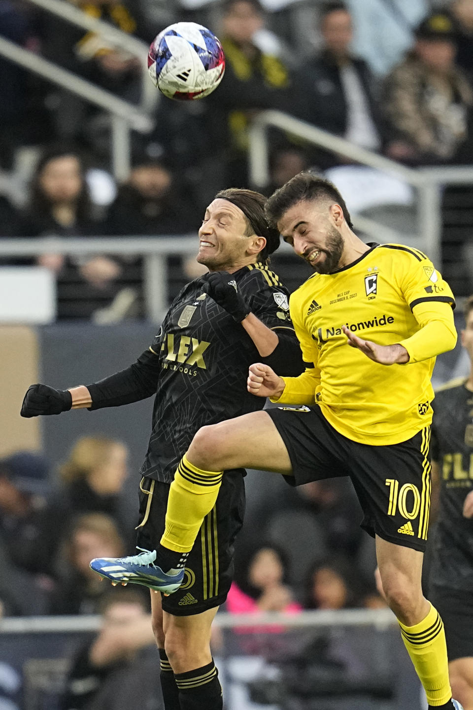 RETRANSMITTING TO CORRECT TEAM TO LOS ANGELES FC - Los Angeles FC's Ilie Sanchez, left, and Columbus Crew's Diego Rossi (10) jump up to head the ball in the first half of the MLS soccer championship match, Saturday, Dec. 9, 2023, in Columbus, Ohio. (AP Photo/Sue Ogrocki)