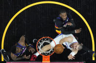 Los Angeles Clippers center Ivica Zubac, right, shoots as Phoenix Suns forward Jae Crowder and center Deandre Ayton, left, defend during the first half of game 2 of the NBA basketball Western Conference Finals, Tuesday, June 22, 2021, in Phoenix. (AP Photo/Matt York)