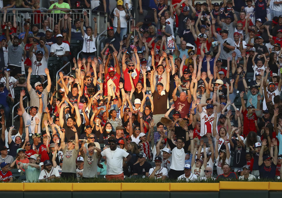 Atlanta Braves fans get the wave going at sunset against the San Francisco Giants during the fourth inning of a baseball game on Monday, June 20, 2022, in Atlanta. (Curtis Compton/Atlanta Journal-Constitution via AP)