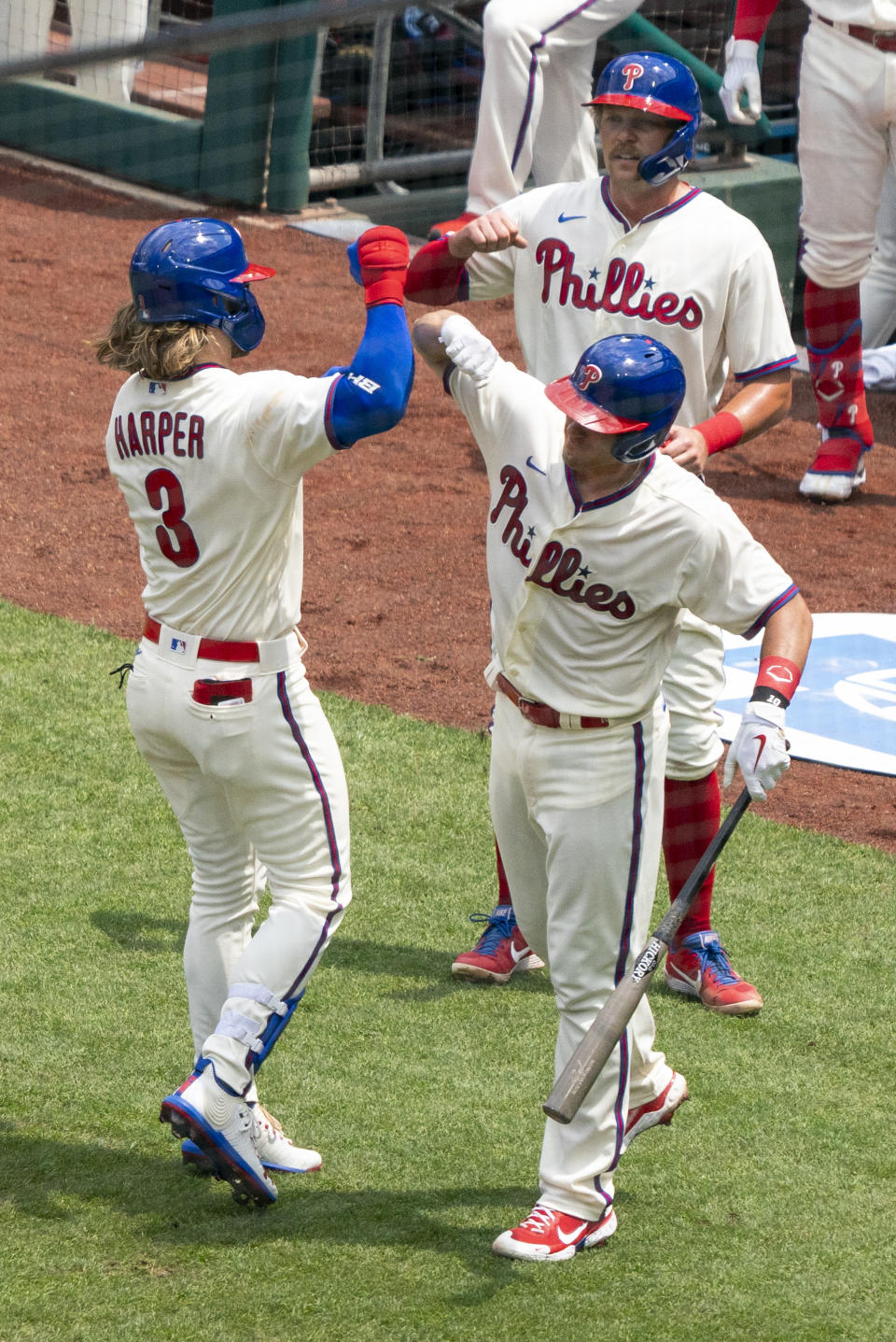 Philadelphia Phillies' Bryce Harper, left, celebrates his three-run home run with J.T. Realmuto, right, during the first inning of a baseball game against the Miami Marlins, Sunday, July 26, 2020, in Philadelphia. (AP Photo/Chris Szagola)