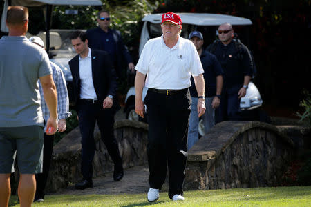 U.S. President Donald Trump arrives to play host to members of the U.S. Coast Guard he invited to play golf at his Trump International Golf Club in West Palm Beach, Florida, U.S., December 29, 2017. REUTERS/Jonathan Ernst