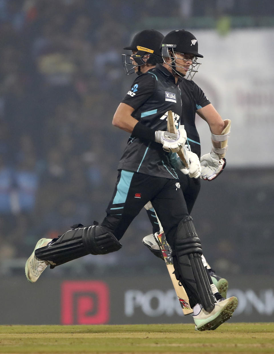 New Zealand's captain Mitchell Santner, front, and batting partner Michael Bracewell run between the wickets to score during the second T20 international cricket match between India and New Zealand in Lucknow, India, Sunday, Jan. 29, 2023. (AP Photo/Surjeet Yadav)