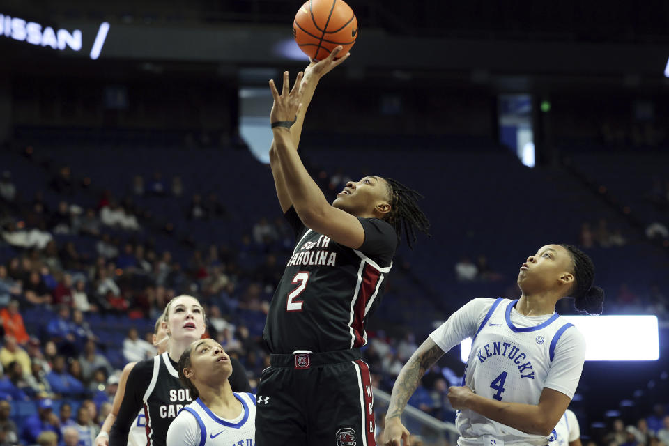 South Carolina's Ashlyn Watkins (2) shoots between Kentucky's Brooklynn Miles, left, and Eniya Russell (4) during the first half of an NCAA college basketball game, Sunday, Feb. 25, 2024, in Lexington, Ky. (AP Photo/James Crisp)