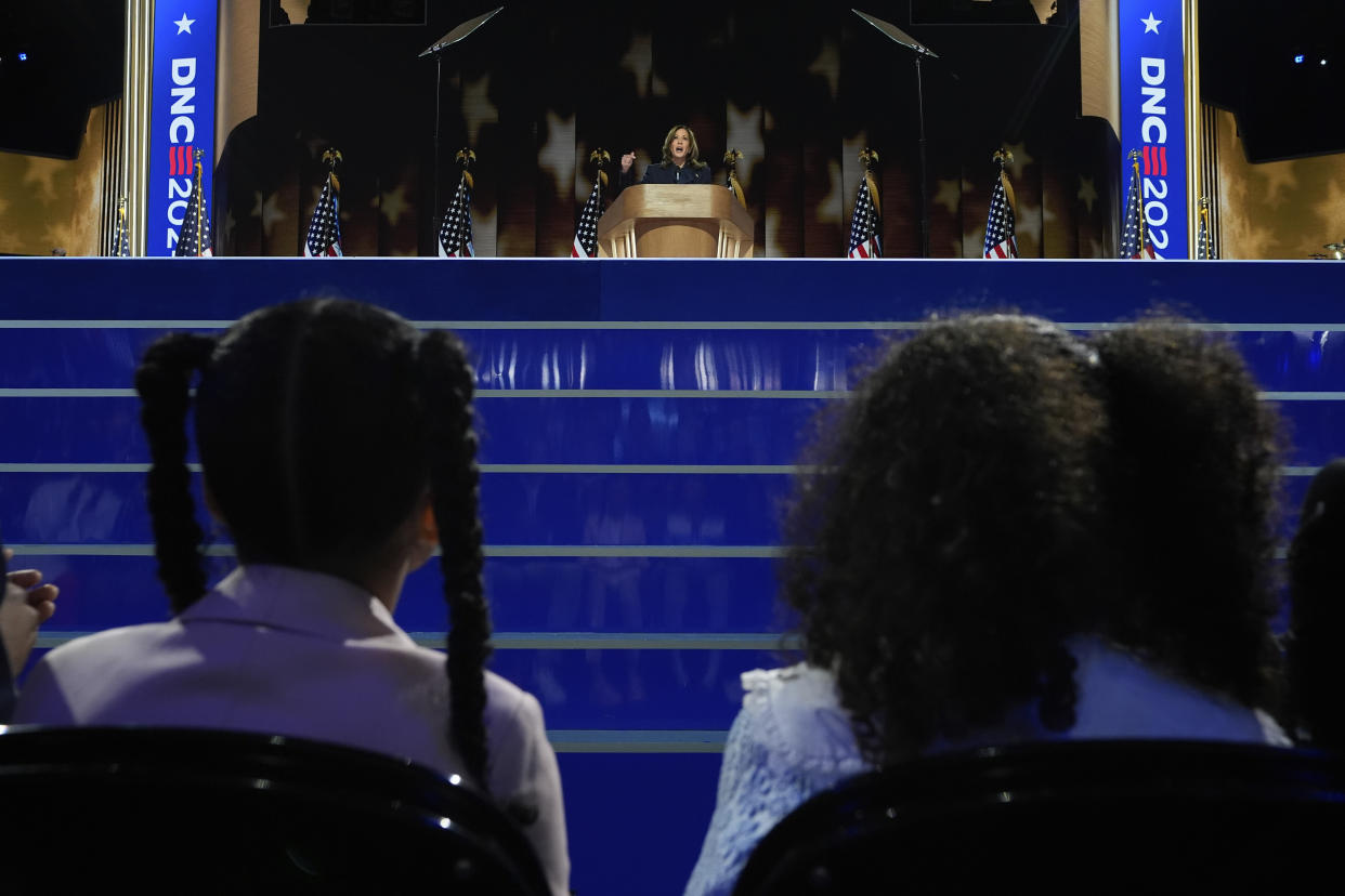 Kamala Harris speaks, as her grandnieces watch, at the Democratic National Convention on Thursday. 