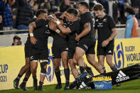New Zealand's Ardie Savea, left, is congratulated by teammates after scoring a try during the rugby international between the All Blacks and Ireland at Eden Park in Auckland, New Zealand, Saturday, July 2, 2022. (Andrew Cornaga/Photosport via AP)