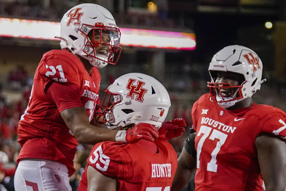 Houston running back Stacy Sneed (21) celebrates his touchdown with offensive lineman Demetrius Hunter during the second half of an NCAA college football game against Sam Houston State, Saturday, Sept. 23, 2023, in Houston. (AP Photo/Eric Christian Smith)