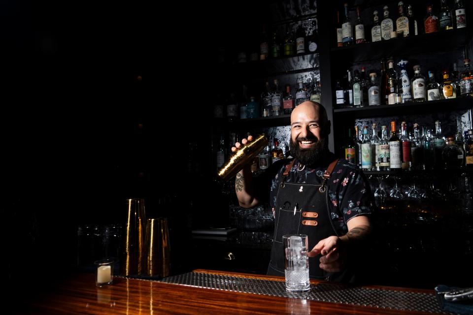 Jorge Viana, beverage director of Bar Mischief, mixes a drink for customers Friday. Mischief is one of the public bars in front of the Inn Cahoots hotel.