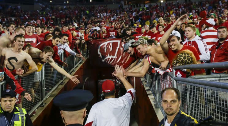 Wisconsin coach Paul Chryst is greeted by fans after Wisconsin beat Nebraska 23-17. (AP)