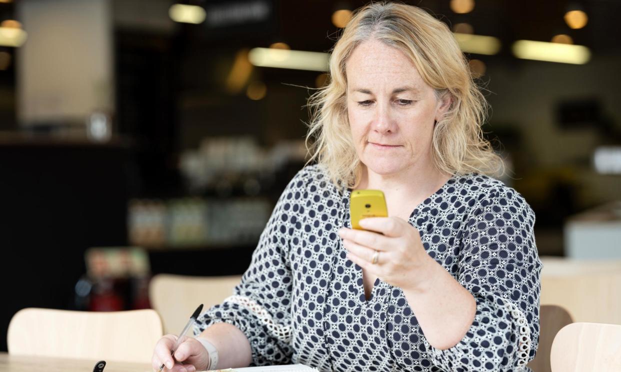 <span>Zoe Wood with the Nokia 3210, first issued in 1999.</span><span>Photograph: Linda Nylind/The Guardian</span>