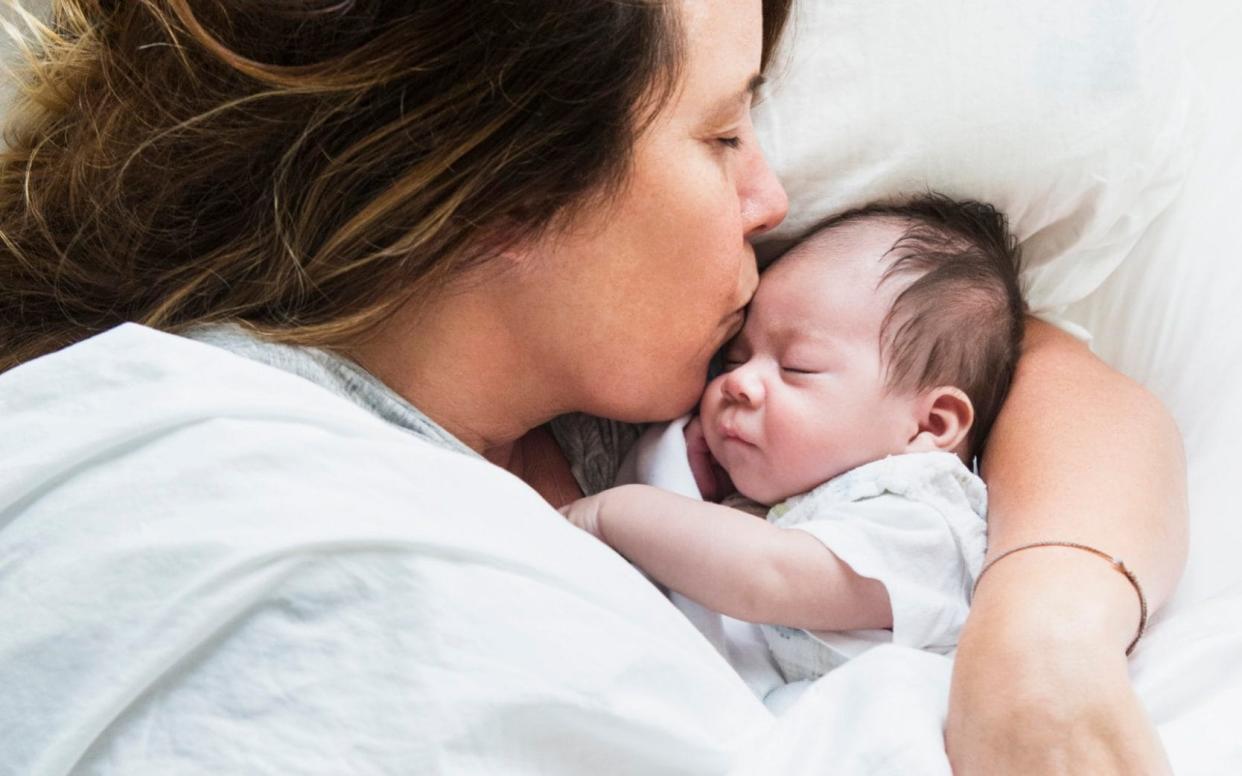 A mother cradles her baby - Lucy von Held/Getty Images