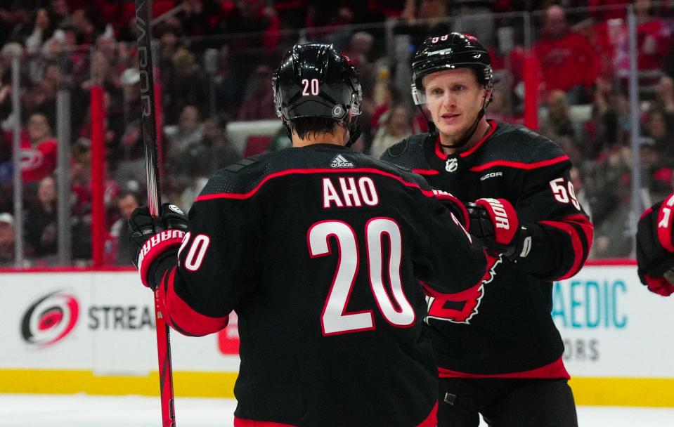 Apr 7, 2024; Raleigh, North Carolina, USA; Carolina Hurricanes center Sebastian Aho (20) is congratulated by center Jake Guentzel (59) after his goal against the Columbus Blue Jackets during the first period at PNC Arena. Mandatory Credit: James Guillory-USA TODAY Sports