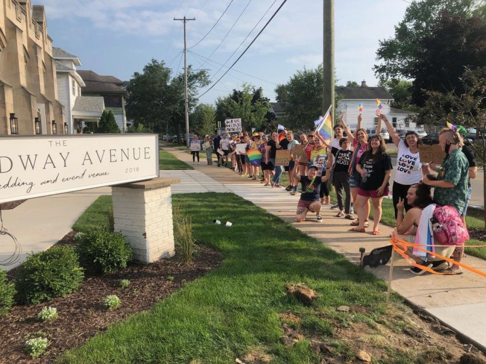 A line of protesters stood outside of The Broadway Avenue in Grand Rapids on July 11, 2022.