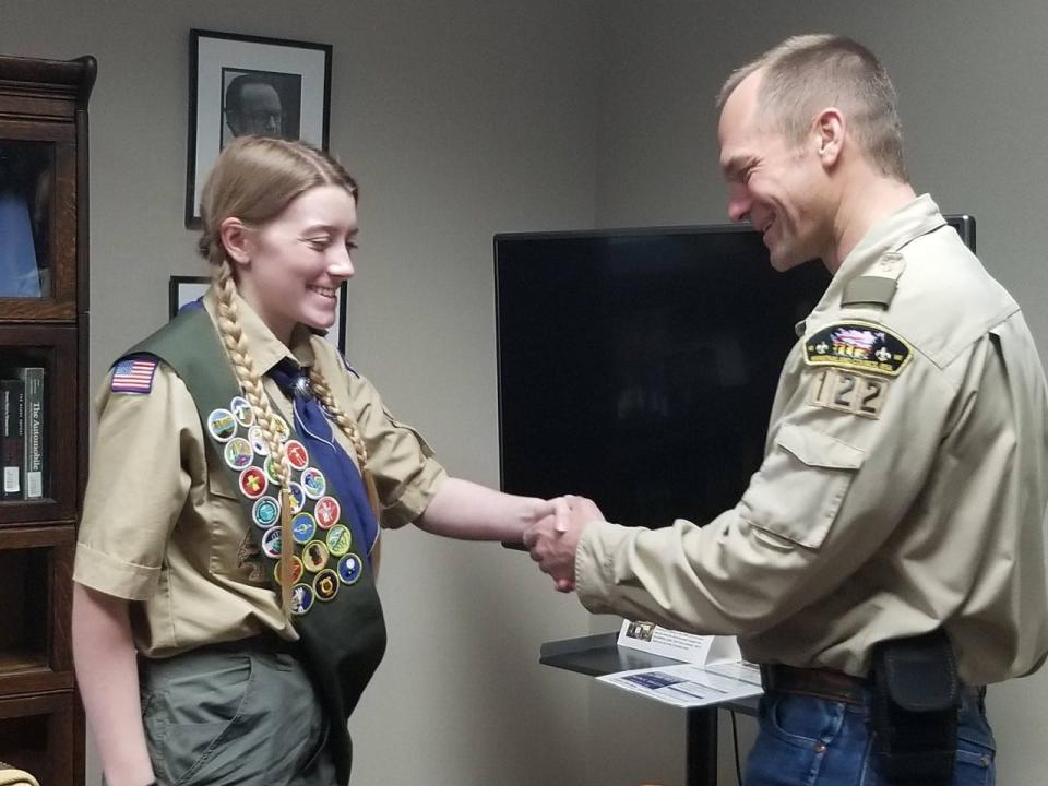 Emily Roe turning in the final credits to earn her Eagle Scout status.