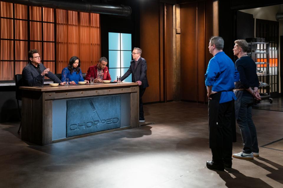 The final round has the judges Scott Conant, Maneet Chauhan, and Marcus Samuelsson with host Ted Allen in a blind taste test, sampling chef Bobby Flay's dish, lobster and salty finger ravioli with red curry coconut sauce and crispy fried milk and duck as Flay and South Shore chef Stephen Coe, look on during the judging of the final round of "Chopped: Beat Bobby Flay."
