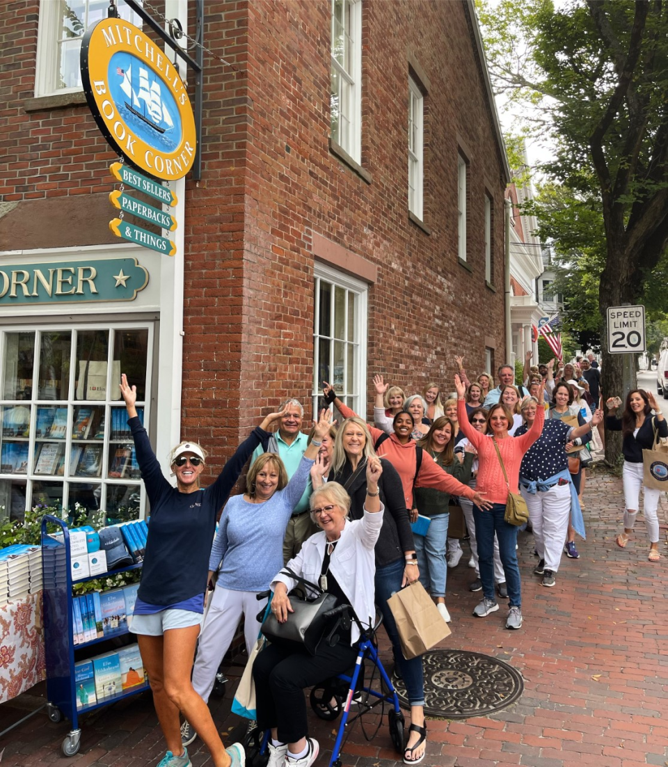 Elin Hilderbrand (foreground) greets Nantucket visitors who line up every Wednesday morning during the summer at Mitchell’s Book Corner to meet her and have their books signed.