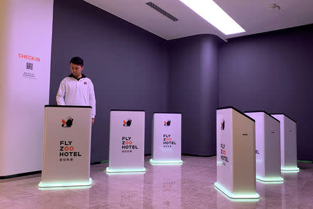 A staff member demonstrates checking in with a podium at Alibaba Group's futuristic FlyZoo hotel in Hangzhou, Zhejiang province, China January 22, 2019. REUTERS/Xihao Jiang