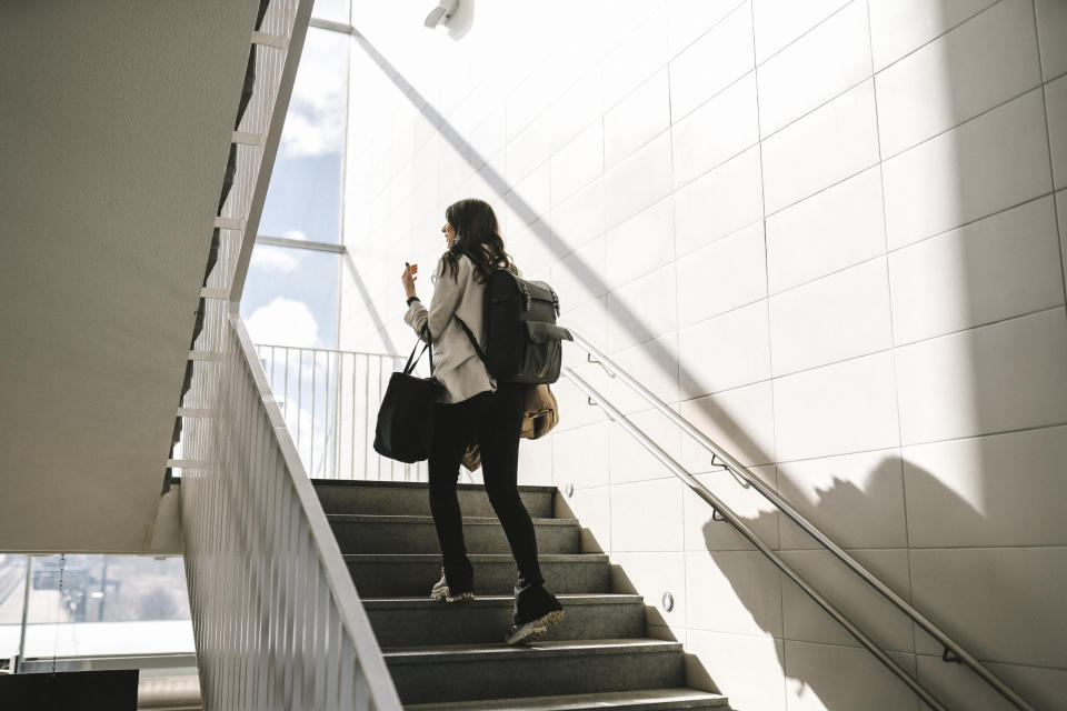 woman walking up a staircase