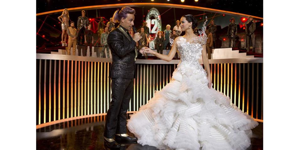 <p>Katniss Everdeen (Jennifer Lawrence) wore her fictional wedding dress to the Quarter Quell's opening ceremony upon President Snow's request. The gown was stunning and up to the Capitol's over-the-top standards—but its best feature showed itself only upon twirl.</p>