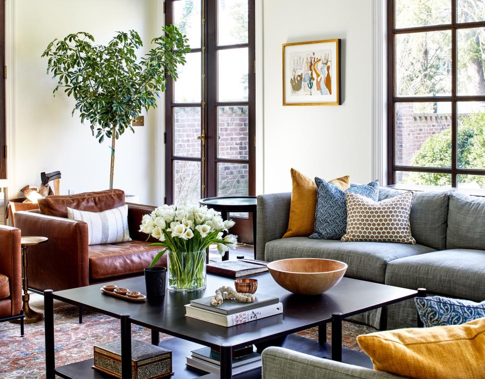 white living room with grey sofa and umbrella plant by Anne Pulliman