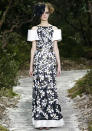 <b>Chanel SS13:</b> A model hits the runway in a monochrome printed gown with white sleeves.<br><br>© Reuters