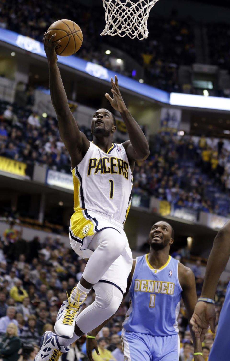 Indiana Pacers guard Lance Stephenson, left, gets a basket in front of Denver Nuggets forward Jordan Hamilton in the second half of an NBA basketball game in Indianapolis, Monday, Feb. 10, 2014. The Pacers won 119-80. (AP Photo/Michael Conroy)