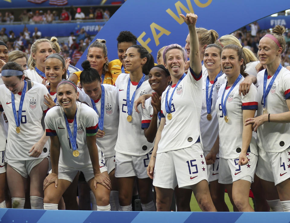 LYON, FRANCE - JULY 7: Alex Morgan, Megan Rapinoe of USA and teammates celebrate the title of World Champions during the podium ceremony following the 2019 FIFA Women's World Cup France Final match between The United State of America (USA) and The Netherlands (Holland) at Groupama Stadium on July 7, 2019 in Decines near Lyon, France. (Photo by Jean Catuffe/Getty Images)