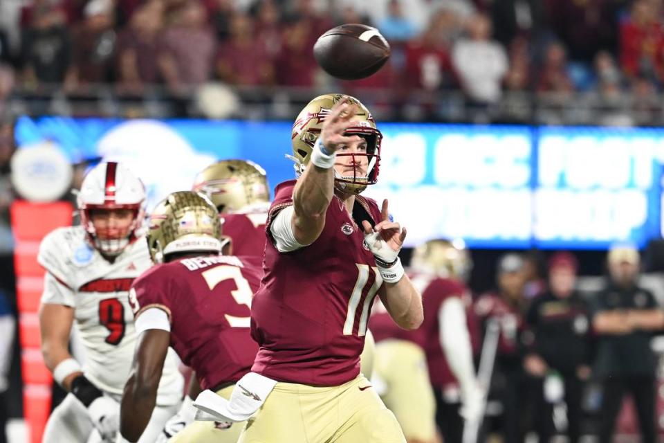 Dec 2, 2023; Charlotte, NC, USA; Florida State Seminoles quarterback Brock Glenn (11) throws against the Louisville Cardinals in the first quarter at Bank of America Stadium.