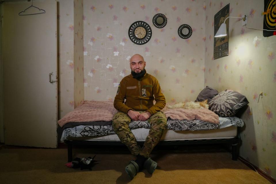 Djinn photographed in his apartment with a dog, Molly, in Kyiv, Ukraine on Jan. 29, 2024. (Olena Zashko / The Kyiv Independent)