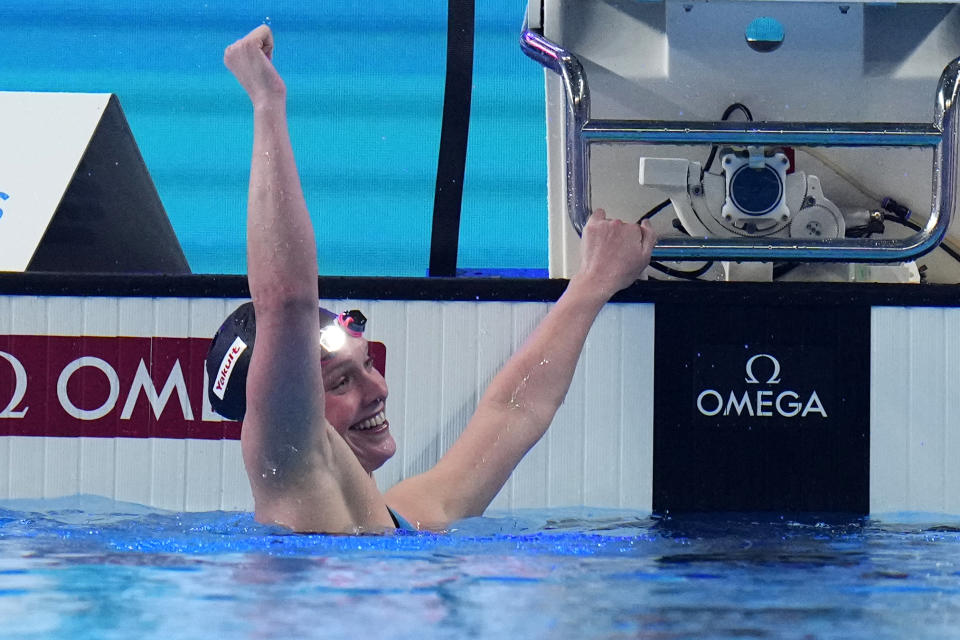 Claire Curzan of the United States celebrates after wining the gold medal in the Women's 100m Backstroke Final at the World Aquatics Championships in Doha, Qatar, Tuesday, Feb. 13, 2024. (AP Photo/Hassan Ammar)