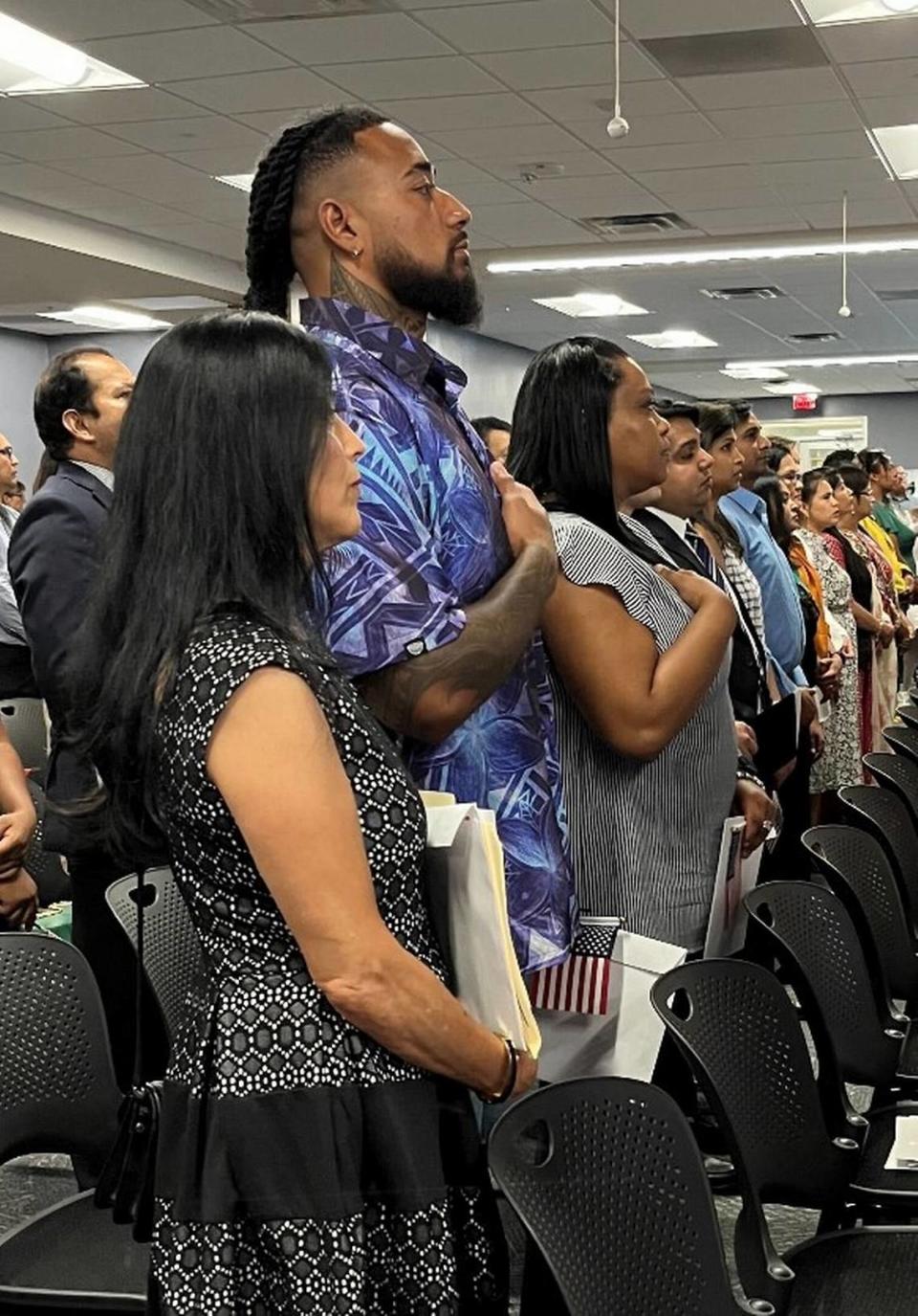 Frankie Luvu (second from left) stands during an American citizenship ceremony in Charlotte in August 2023.