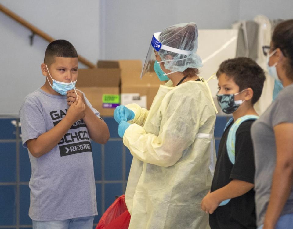 <div class="inline-image__caption"><p>A medical professional oversees as a fifth-grader gives himself a rapid COVID-19 test on the first day of school at Montara Avenue Elementary School in Los Angeles.</p></div> <div class="inline-image__credit">Allen J. Schaben / Los Angeles Times via Getty Images</div>