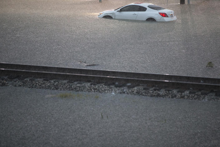 A flooded out car is stranded in high water off U.S. 59 as rain from Tropical Depression Imelda inundated the area on Sept. 19, 2019, near Spendora, Texas. (Photo: Brett Coomer/Houston Chronicle via AP)