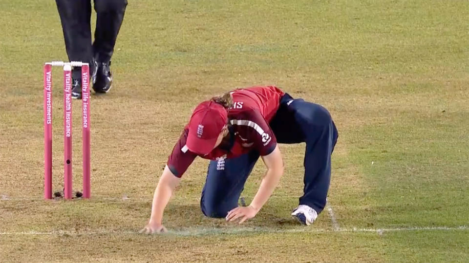 Seen here, an England player spreads the sawdust into the pitch.