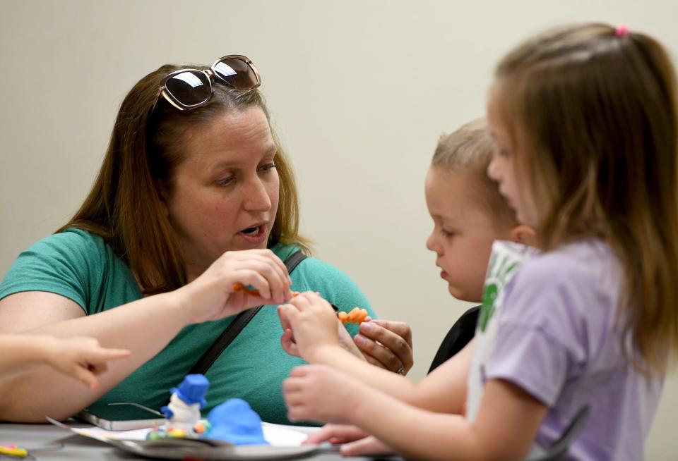 Kelli Liddle of North Canton works on projects with her children Mason, 4, and Peyton Liddle, 7, during the Family Art Party at the North Canton Public Library.